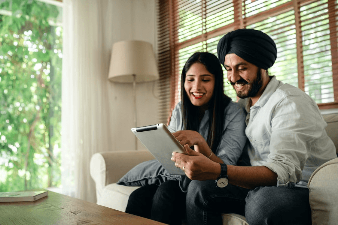 Couple reviewing a curated shortlist of properties on a tablet